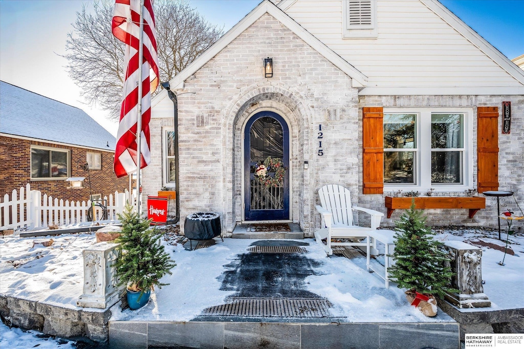 view of snow covered property entrance