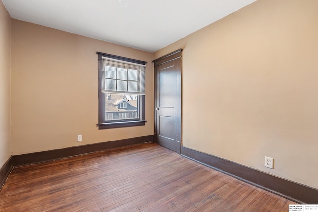 spare room with dark hardwood / wood-style flooring