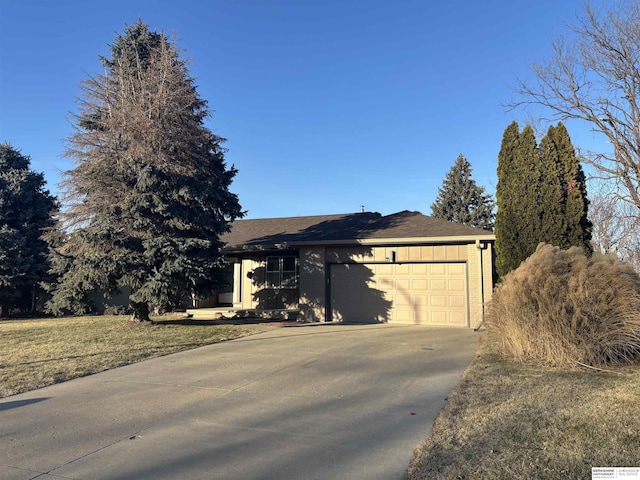 single story home featuring a front lawn and a garage