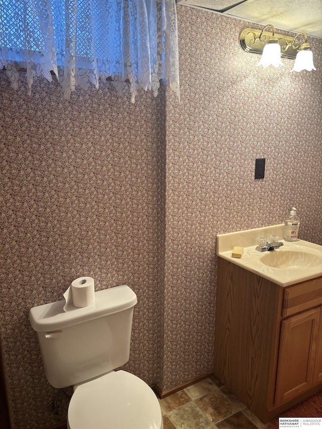 bathroom with toilet and vanity