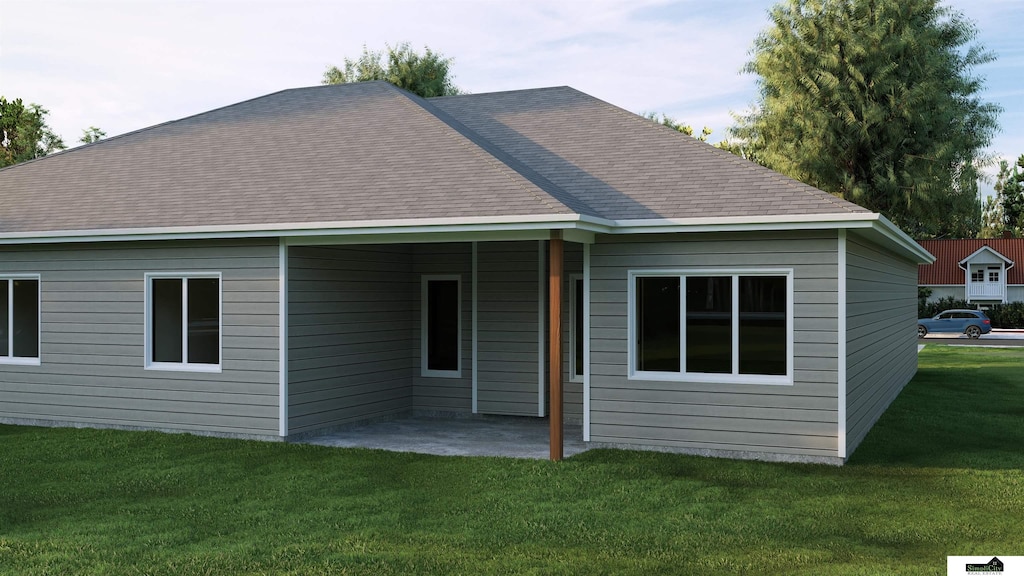 rear view of house featuring a yard and a patio area