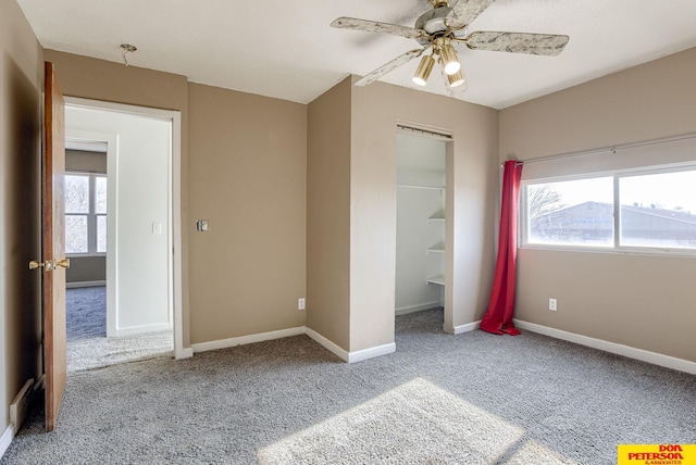 unfurnished bedroom with ceiling fan, a closet, and carpet