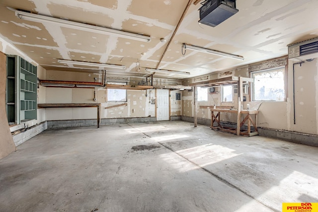 interior space with a garage door opener and a workshop area