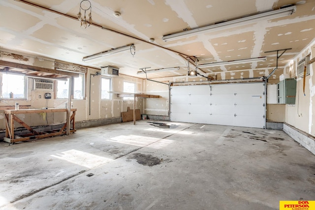 garage with an AC wall unit and a garage door opener