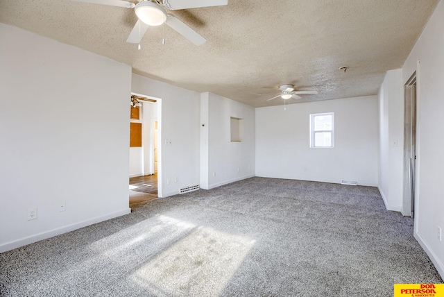 spare room with a textured ceiling, ceiling fan, and carpet flooring