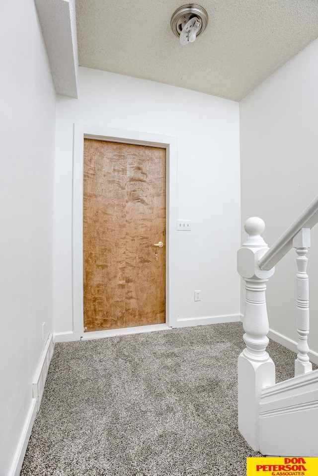 carpeted spare room featuring a textured ceiling