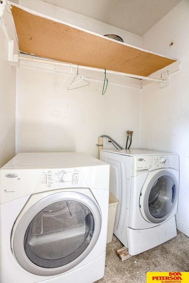 washroom with washer and dryer and light carpet