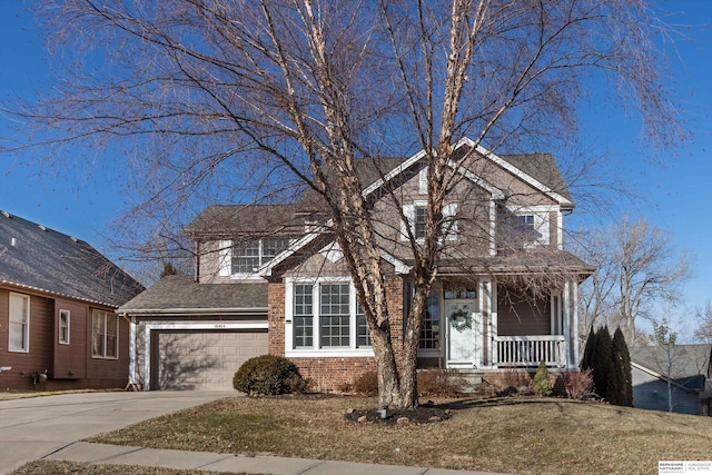 front of property featuring a porch, a front lawn, and a garage