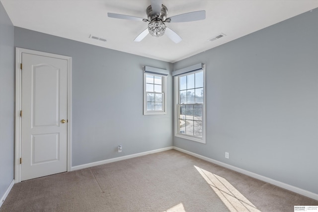 carpeted empty room featuring ceiling fan