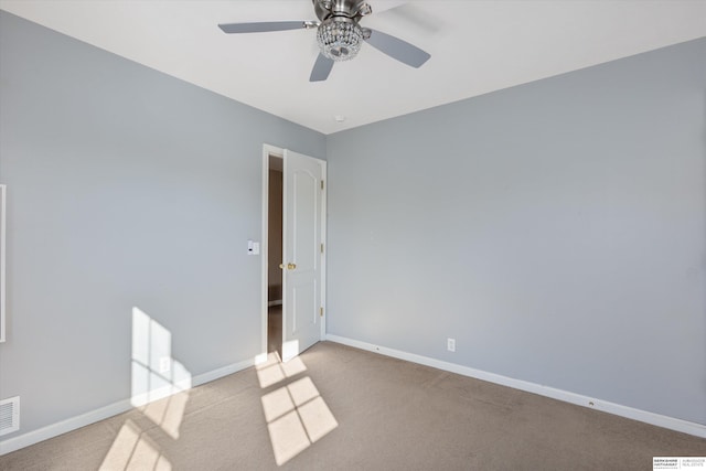 spare room with light colored carpet and ceiling fan