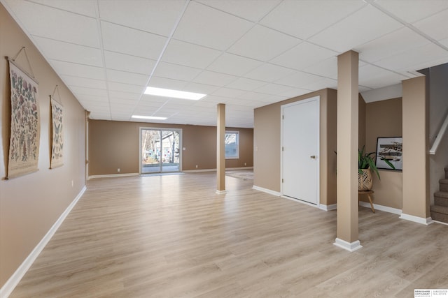 basement with light wood-type flooring and a drop ceiling