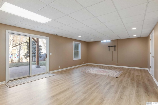 interior space featuring light hardwood / wood-style flooring and a drop ceiling