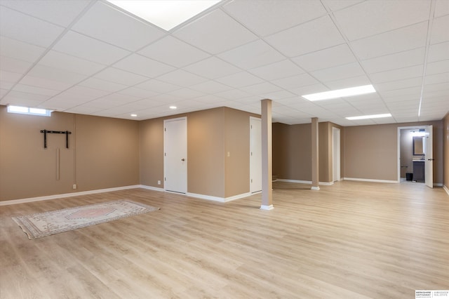 basement with light hardwood / wood-style flooring