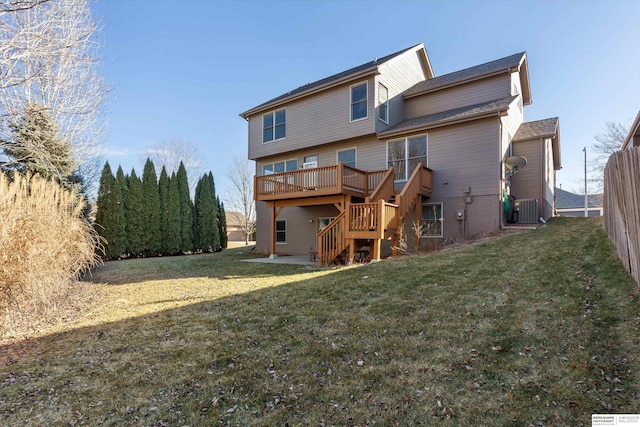 back of property featuring cooling unit, a deck, and a yard