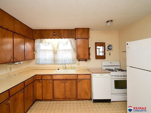 kitchen featuring white appliances and sink