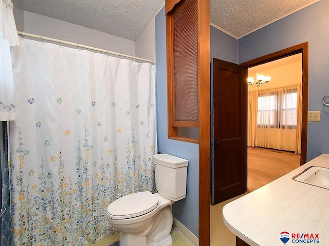 bathroom featuring toilet, vanity, a textured ceiling, and an inviting chandelier