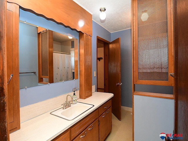 bathroom with a textured ceiling and vanity