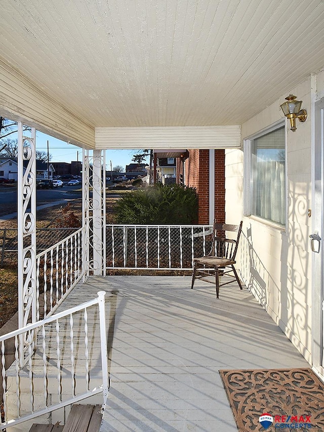 wooden terrace featuring covered porch