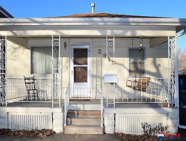 view of exterior entry with a porch