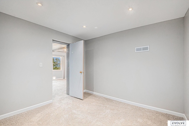 empty room with light colored carpet