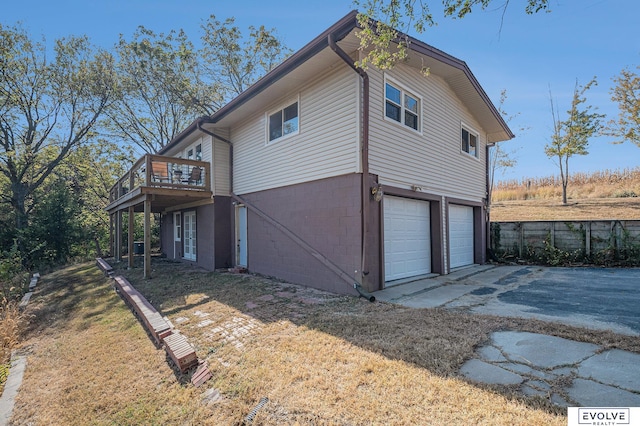 view of property exterior featuring a deck and a garage