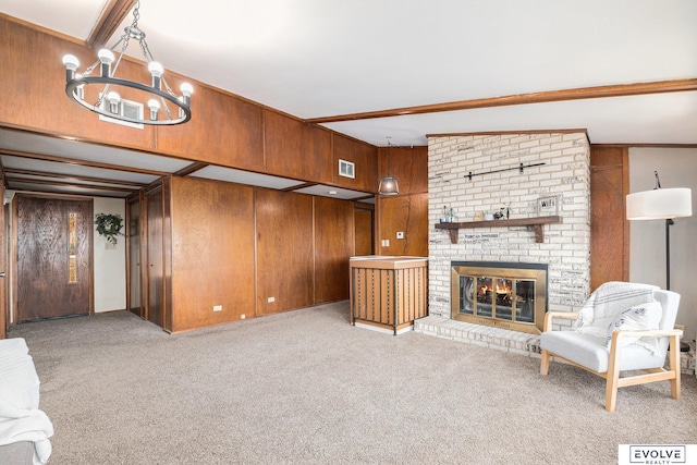 unfurnished living room with light carpet, a brick fireplace, wood walls, lofted ceiling with beams, and a notable chandelier