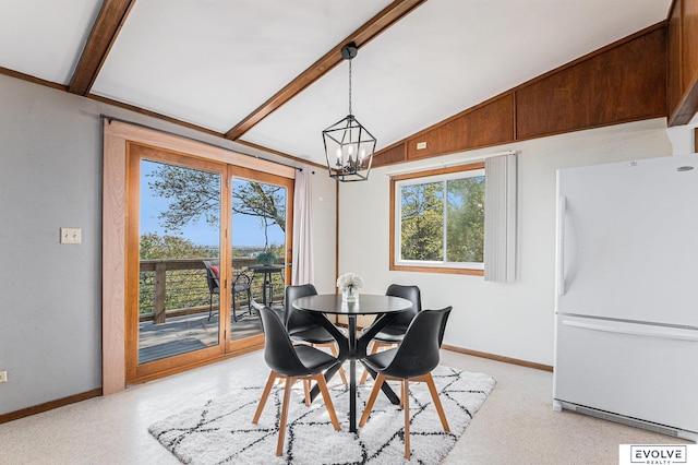 dining area with a notable chandelier and lofted ceiling with beams