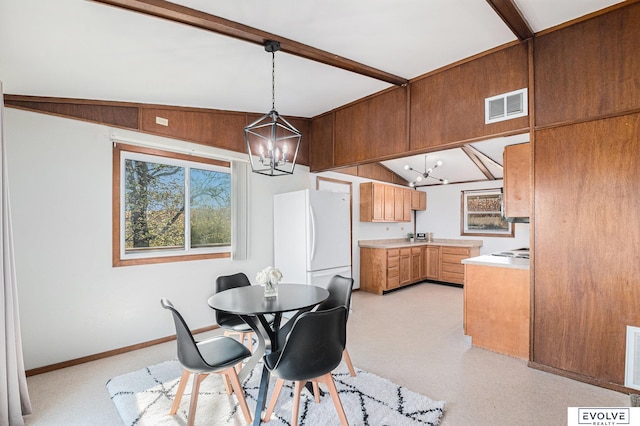 dining room featuring an inviting chandelier and lofted ceiling with beams