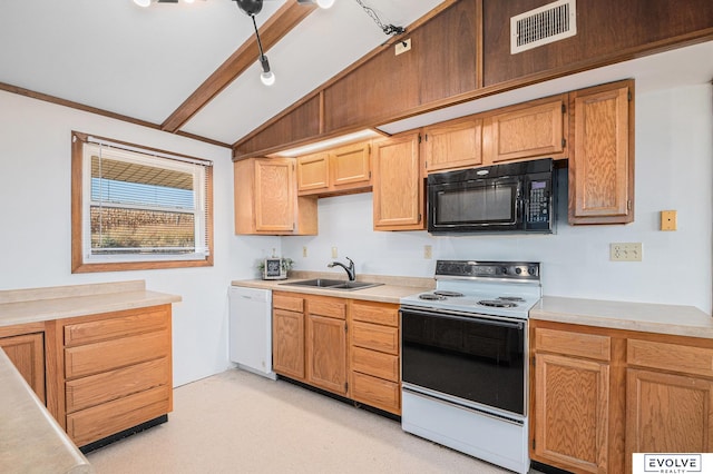 kitchen with white appliances, vaulted ceiling with beams, and sink