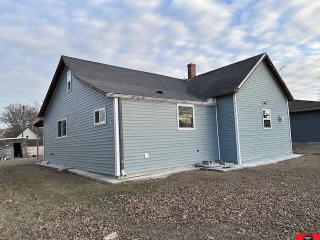 view of side of property with a yard