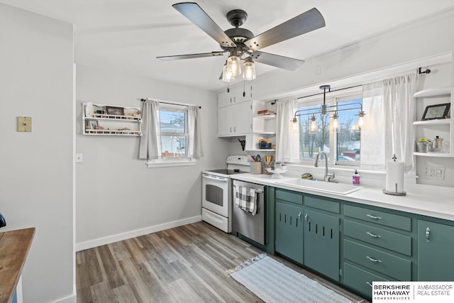 kitchen with white range with electric stovetop, green cabinetry, sink, stainless steel dishwasher, and ceiling fan with notable chandelier