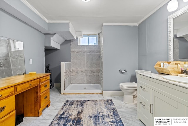 bathroom with toilet, ornamental molding, tiled shower, and vanity