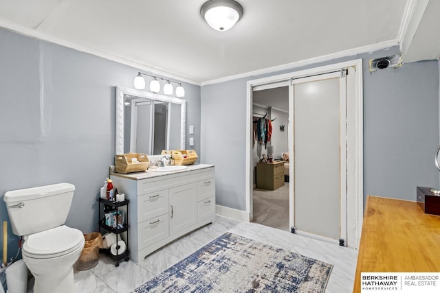 bathroom with crown molding, vanity, and toilet