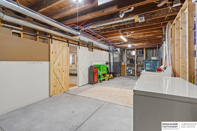 basement featuring independent washer and dryer and fridge