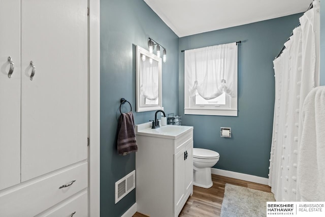 bathroom with toilet, wood-type flooring, and vanity