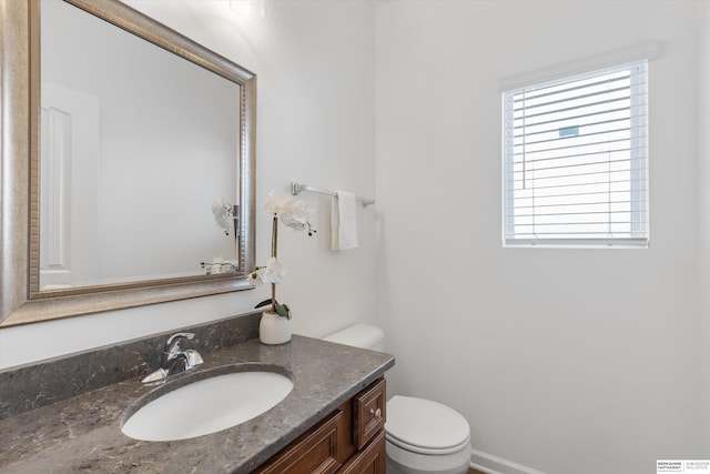 bathroom featuring toilet and vanity