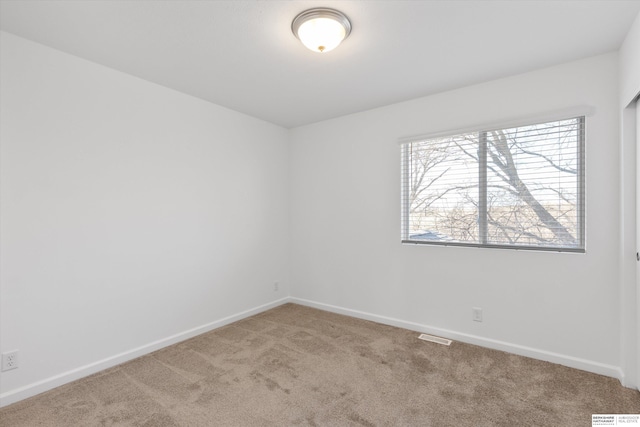 unfurnished room featuring carpet