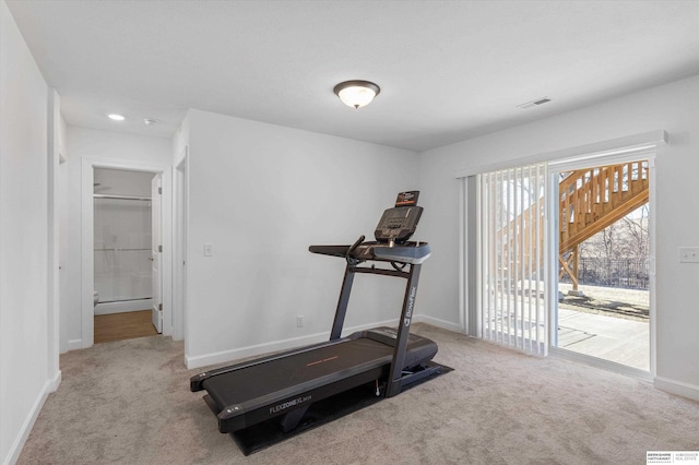 workout area featuring light carpet