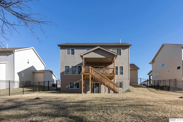 back of house with a lawn and a wooden deck