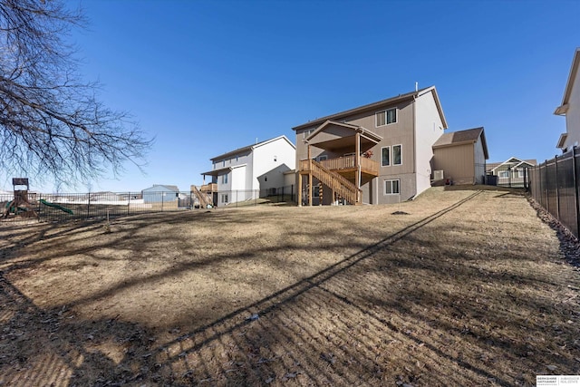 rear view of house featuring a yard