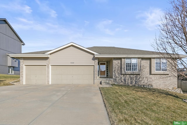 ranch-style house with a garage and a front lawn