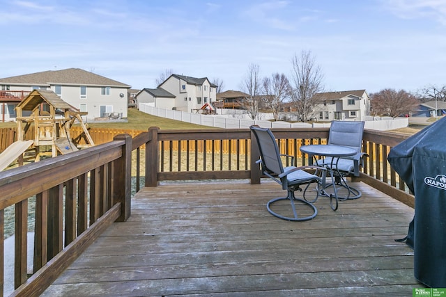 wooden terrace featuring a yard and a playground