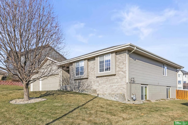 view of home's exterior with a lawn and a garage