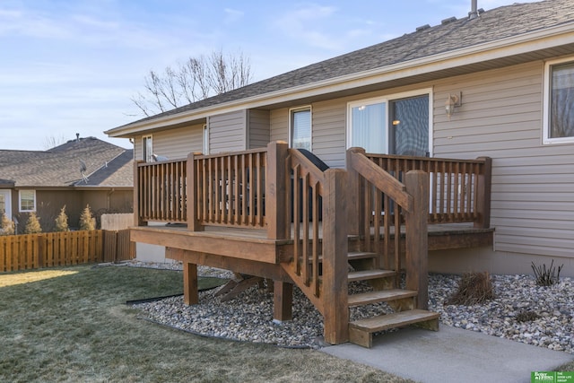 wooden deck featuring a yard