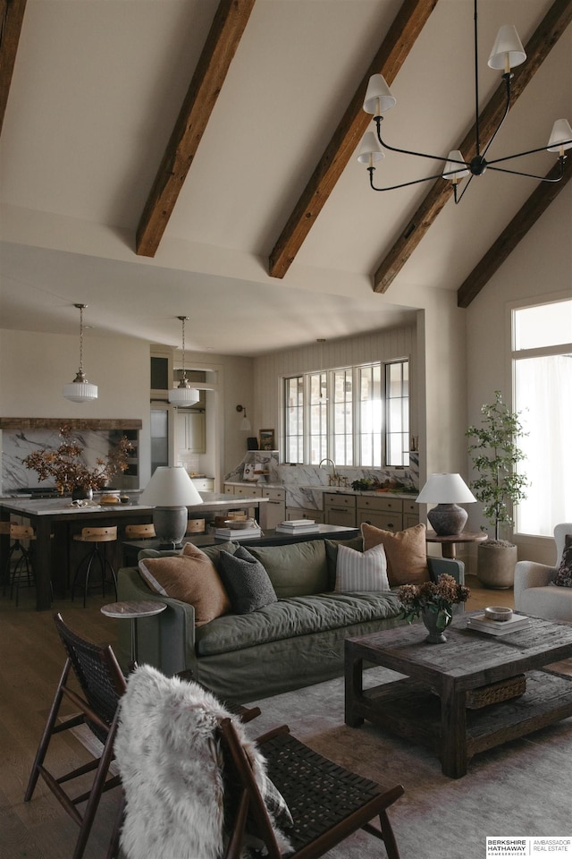 living room with wood-type flooring, a chandelier, and lofted ceiling with beams