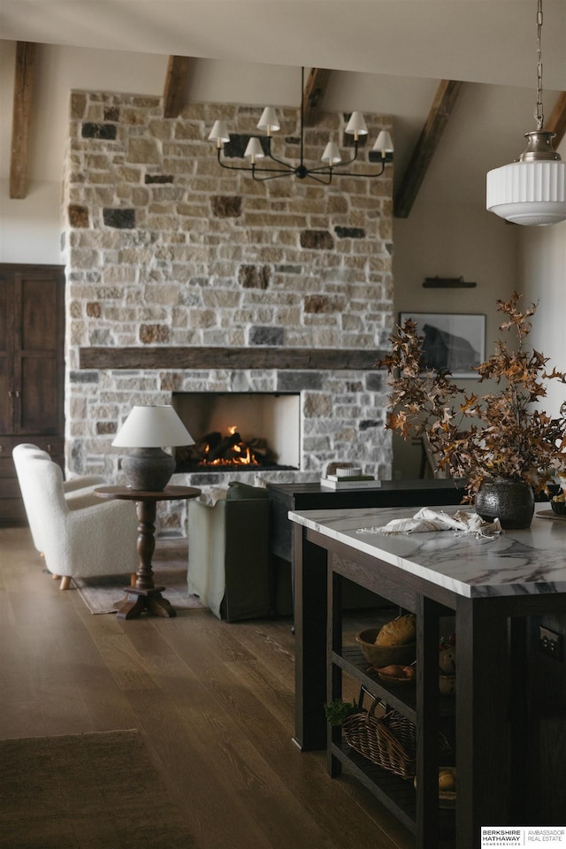 kitchen featuring a stone fireplace, pendant lighting, high vaulted ceiling, dark hardwood / wood-style floors, and beam ceiling