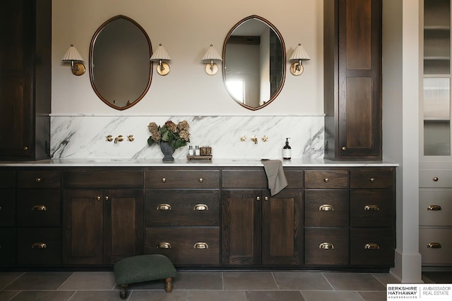 bathroom featuring vanity and tasteful backsplash