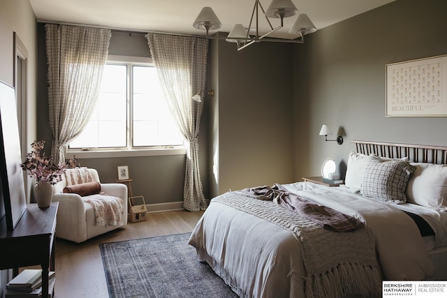 bedroom featuring a chandelier and hardwood / wood-style floors