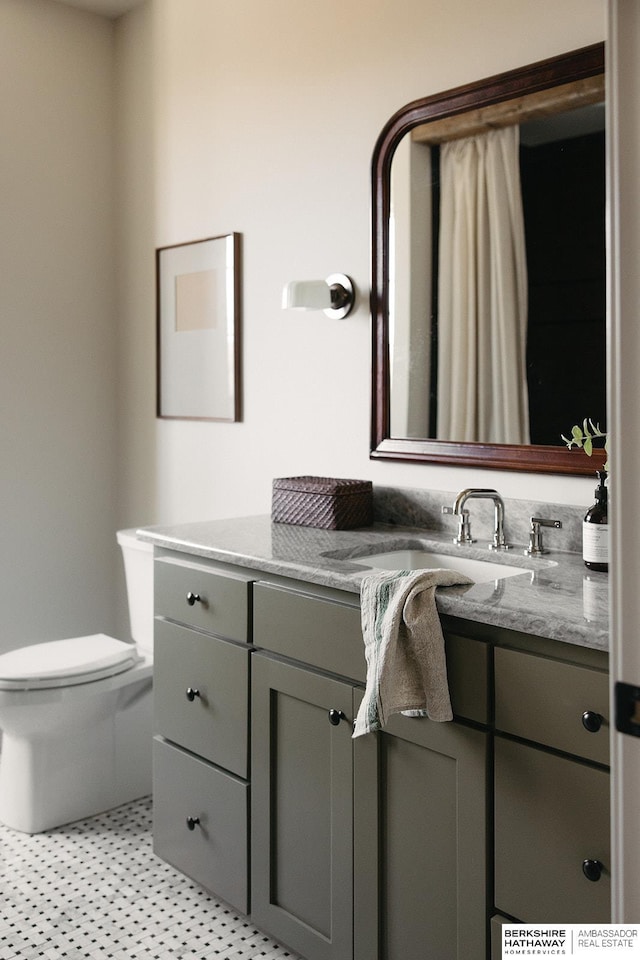 bathroom with toilet and vanity