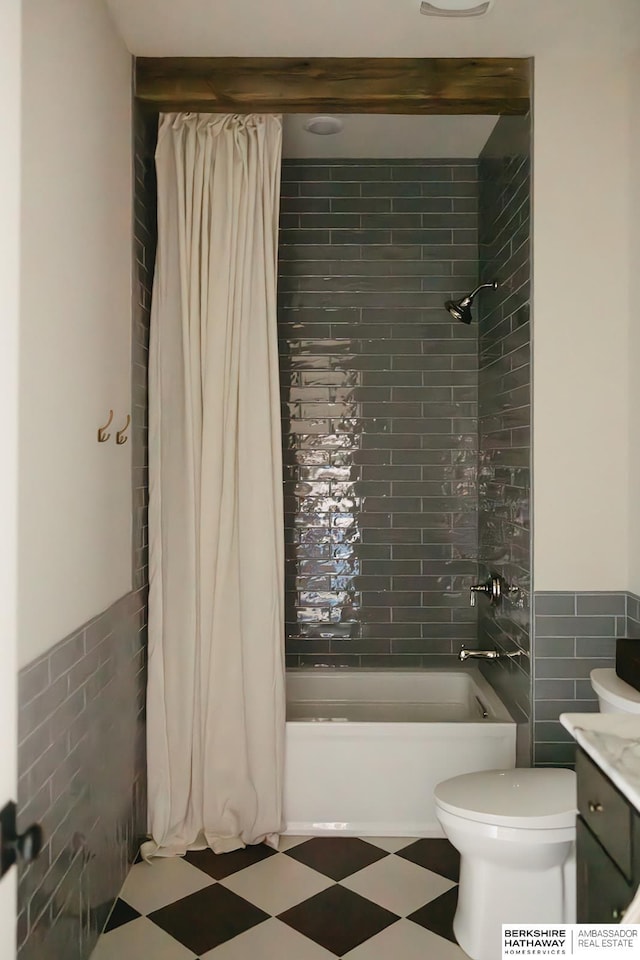 full bathroom featuring tile walls, shower / bathtub combination with curtain, toilet, and vanity